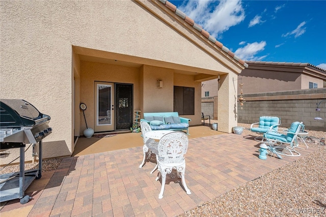 view of patio / terrace with a grill and fence