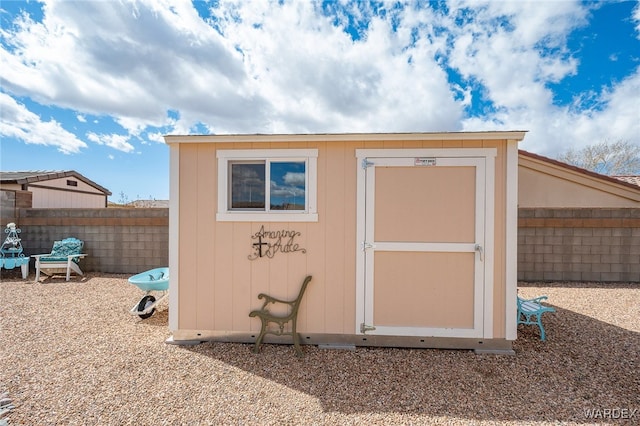 view of shed featuring fence