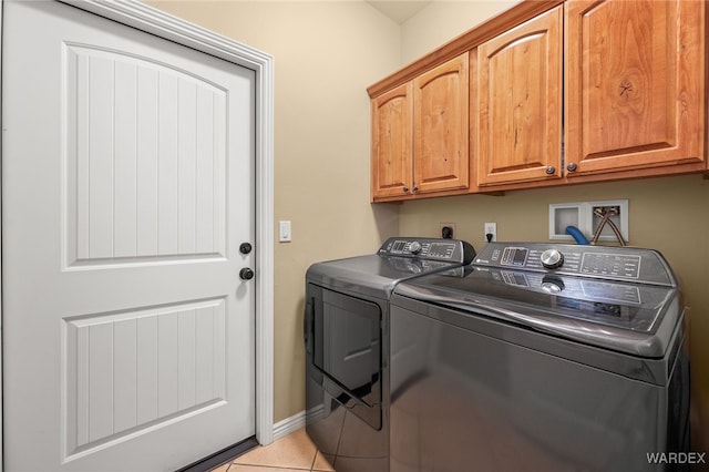 laundry room with tile patterned floors, baseboards, cabinet space, and independent washer and dryer