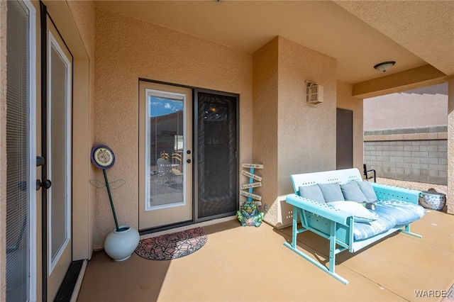 doorway to property featuring stucco siding