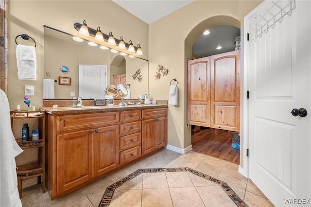 full bath featuring tile patterned floors, a sink, recessed lighting, double vanity, and baseboards