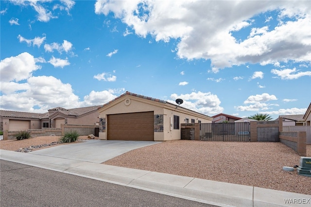 view of front of house with a fenced front yard, a gate, a garage, and driveway