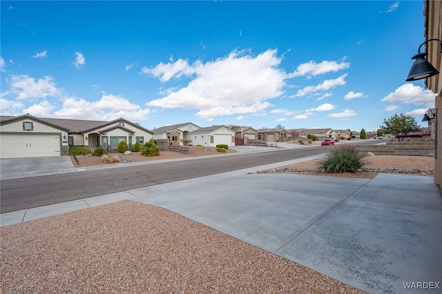 view of yard featuring a residential view and driveway