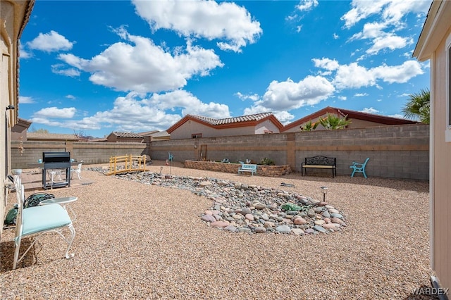 view of yard featuring a patio area and a fenced backyard