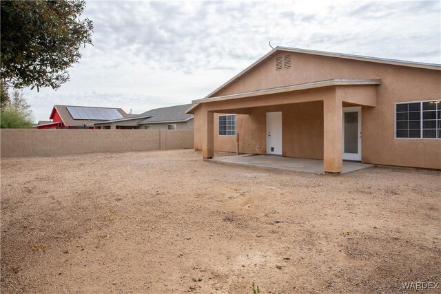 back of house with a patio, a fenced backyard, and stucco siding