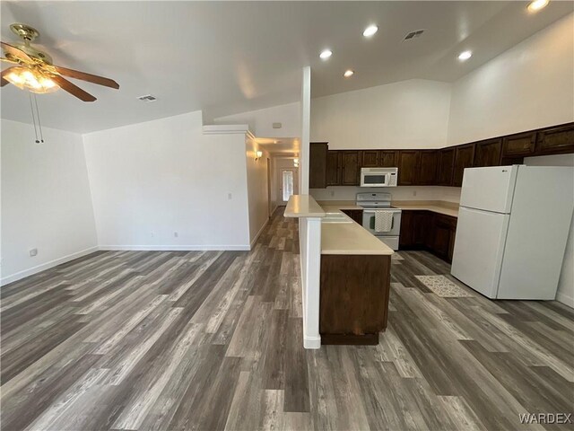 kitchen with dark brown cabinetry, white appliances, visible vents, open floor plan, and light countertops