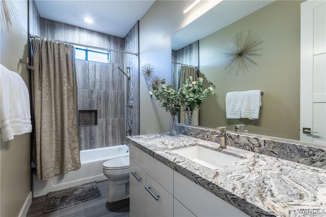 full bath with shower / bath combo, vanity, toilet, and wood finished floors