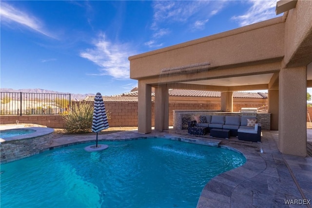 view of pool featuring a fenced backyard, an in ground hot tub, exterior kitchen, a fenced in pool, and a patio area