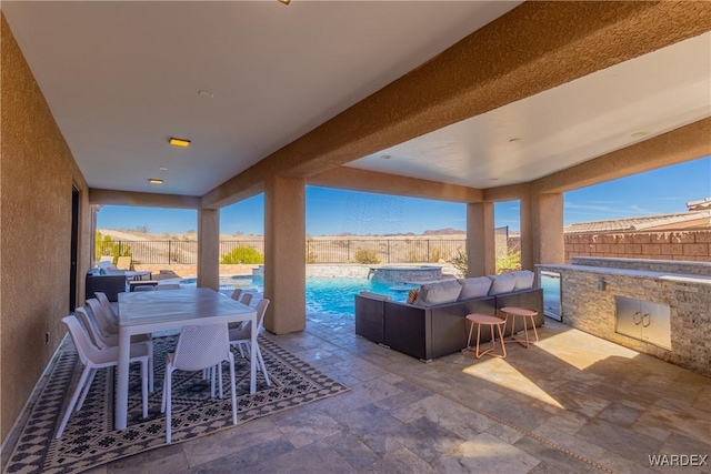 view of patio / terrace featuring outdoor dining area, a fenced backyard, and a fenced in pool