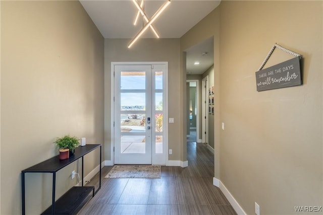 entryway with dark wood-style flooring and baseboards