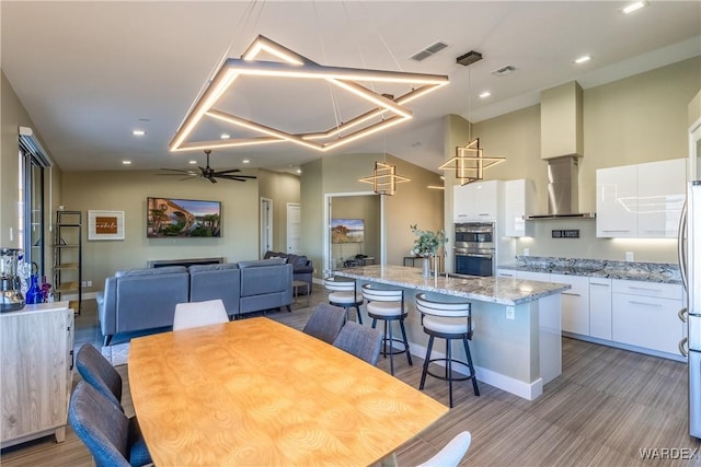 dining space featuring a ceiling fan, recessed lighting, visible vents, and high vaulted ceiling