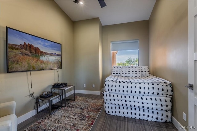 bedroom featuring dark wood-type flooring, ceiling fan, and baseboards