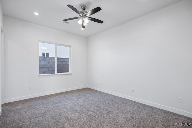 spare room with ceiling fan, visible vents, baseboards, and carpet flooring