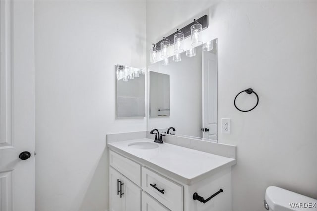 bathroom featuring vanity and toilet