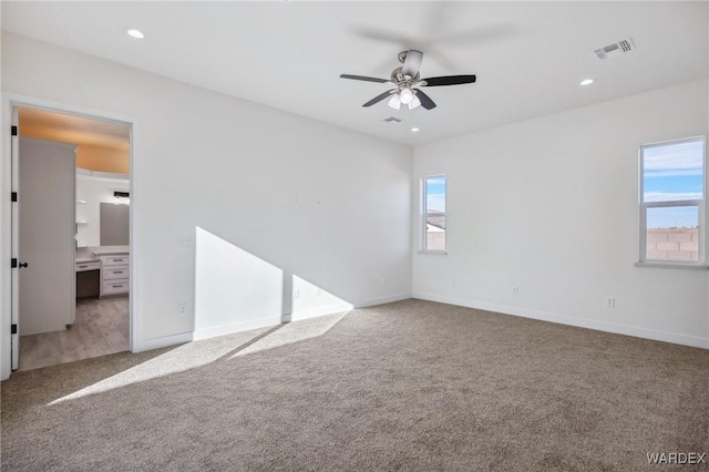 carpeted empty room with baseboards, ceiling fan, recessed lighting, and a healthy amount of sunlight