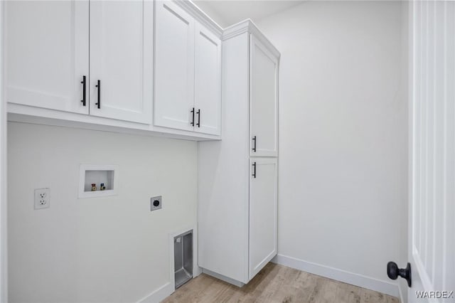 laundry room featuring cabinet space, baseboards, light wood-style floors, washer hookup, and electric dryer hookup