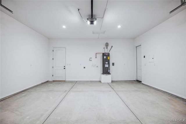 garage with a garage door opener, recessed lighting, and electric water heater