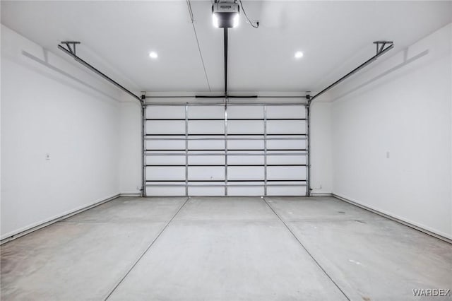 garage with a garage door opener, recessed lighting, and baseboards