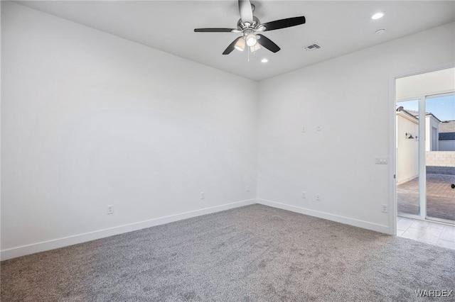 spare room with a ceiling fan, recessed lighting, light colored carpet, and baseboards