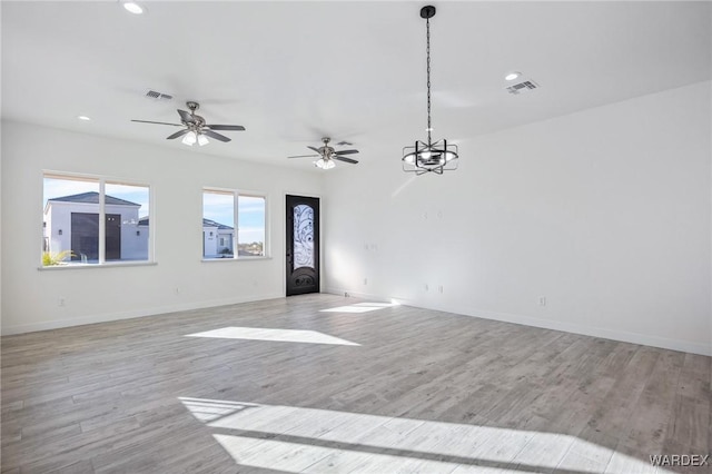 unfurnished living room featuring light wood-style floors, baseboards, visible vents, and recessed lighting