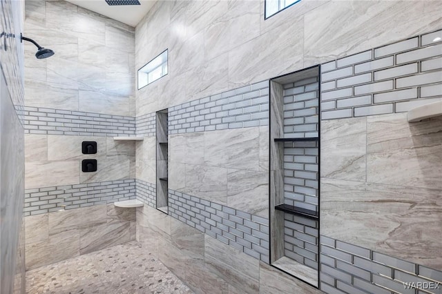 bathroom with tiled shower