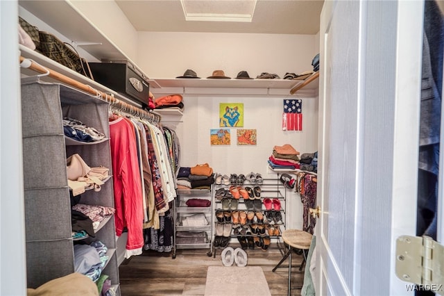 walk in closet with wood finished floors