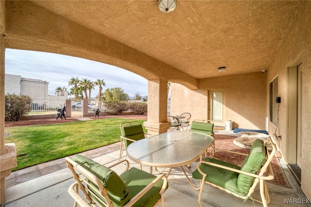 view of patio / terrace with outdoor dining space and fence