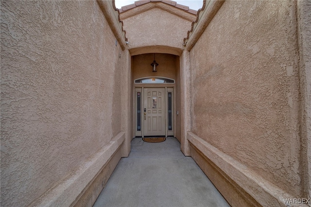 property entrance with stucco siding