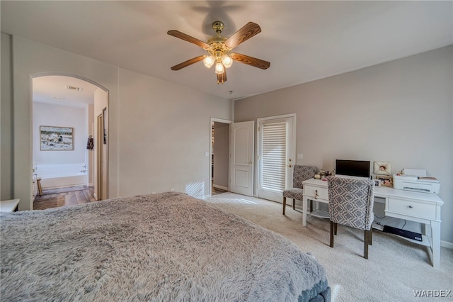 bedroom featuring light carpet, visible vents, arched walkways, a ceiling fan, and a closet