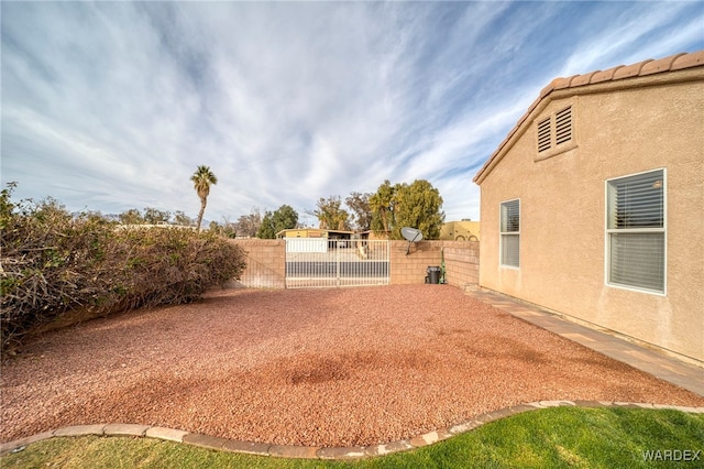 view of yard with a fenced backyard and a patio