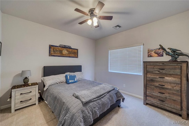 bedroom with light carpet, a ceiling fan, visible vents, and baseboards