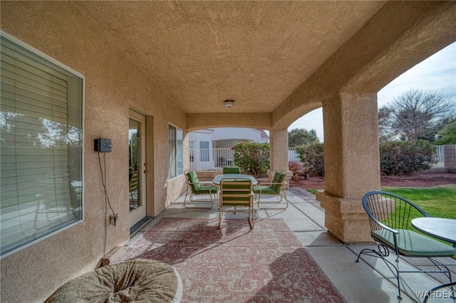 view of patio featuring fence