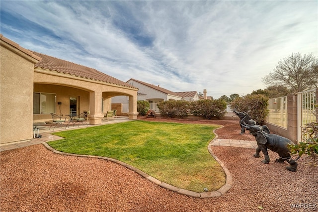 view of yard featuring fence and a patio