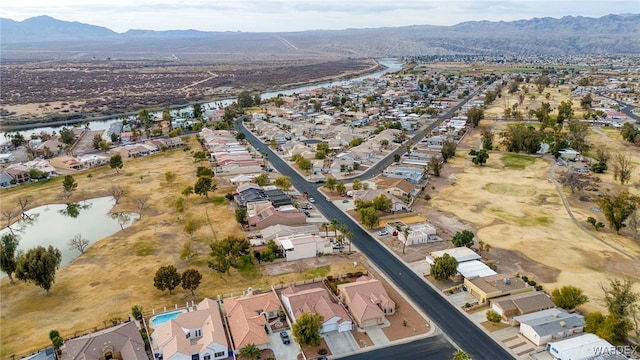 drone / aerial view with a residential view and a water and mountain view