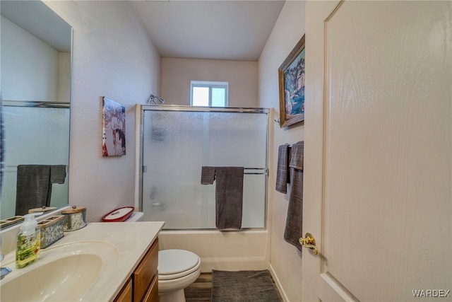 bathroom featuring shower / bath combination with glass door, vanity, and toilet