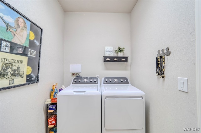 laundry room featuring washing machine and dryer and laundry area