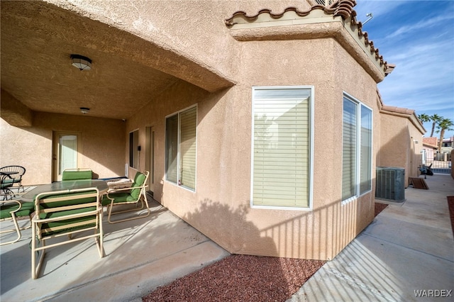 exterior space with central AC, a patio, and stucco siding