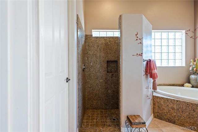 full bathroom with a walk in shower, plenty of natural light, and tile patterned floors