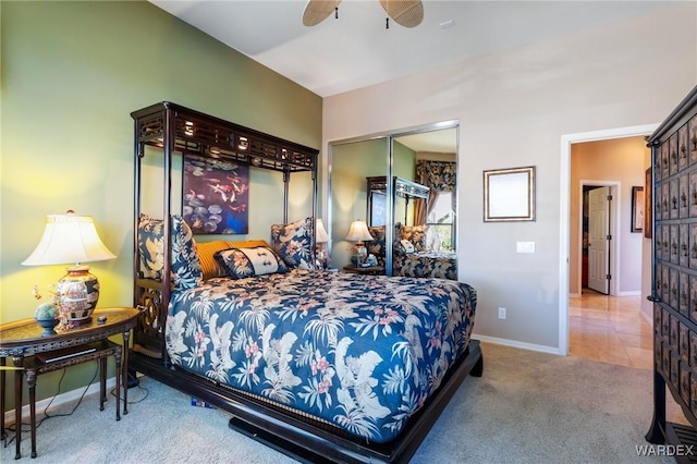 carpeted bedroom featuring a ceiling fan, baseboards, and a closet