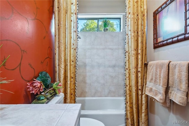 bathroom with shower / bath combo, vanity, and toilet