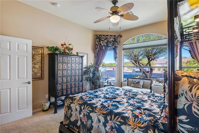 bedroom with carpet, a ceiling fan, and baseboards