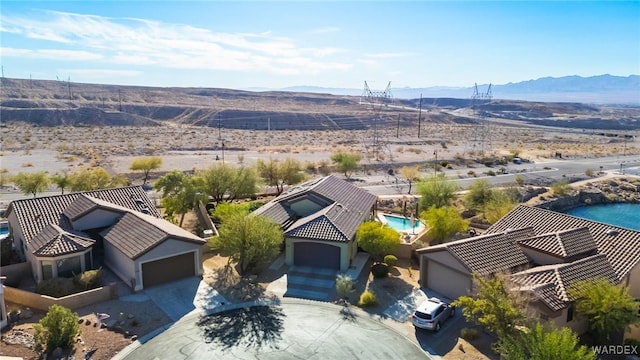 birds eye view of property with a mountain view