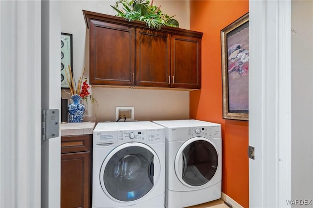 laundry area featuring cabinet space and independent washer and dryer