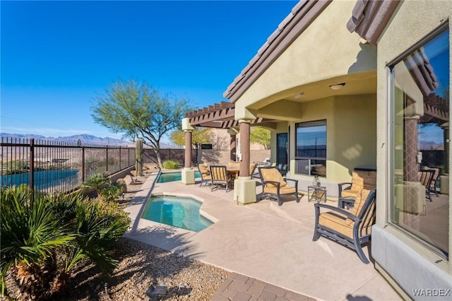 view of swimming pool featuring a patio, a fenced backyard, a mountain view, a fenced in pool, and a pergola