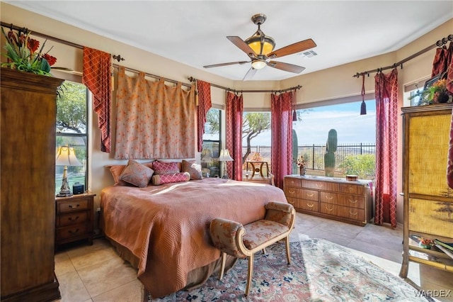 bedroom featuring visible vents, a ceiling fan, and light tile patterned flooring