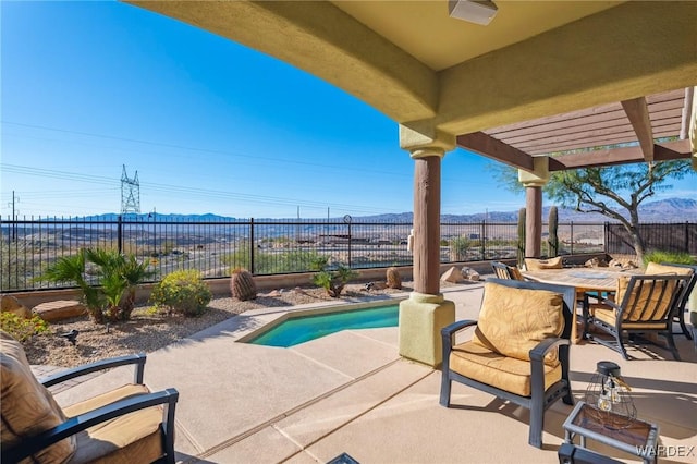 view of patio / terrace with a fenced backyard, a fenced in pool, a mountain view, and a pergola