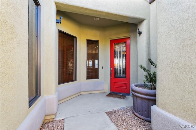 entrance to property with stucco siding