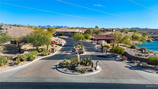 exterior space featuring a residential view and decorative driveway