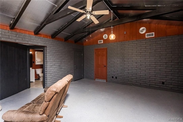 interior space featuring visible vents, ceiling fan, and brick wall