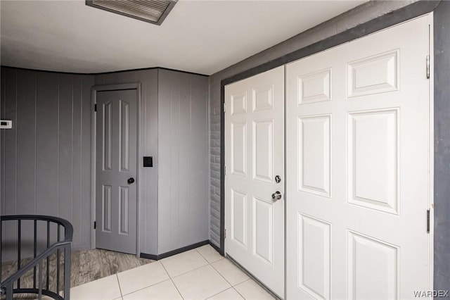 bedroom featuring light tile patterned floors and visible vents